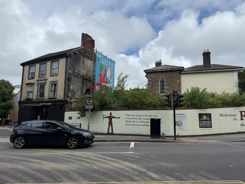 Street view of a mixed-use commercial and residential property in Redruth, Cornwall, with adjoining land