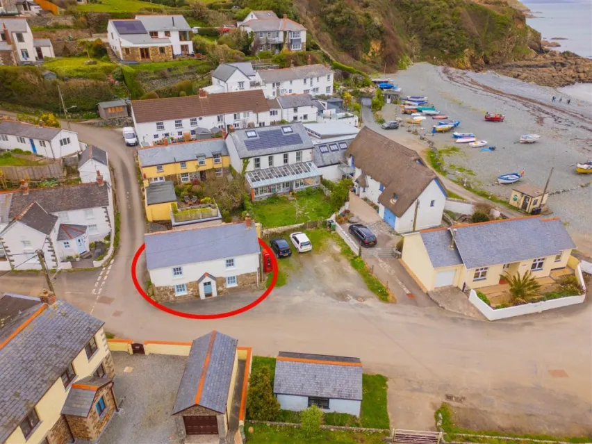 Aerial view of houses next to a beach and the sea