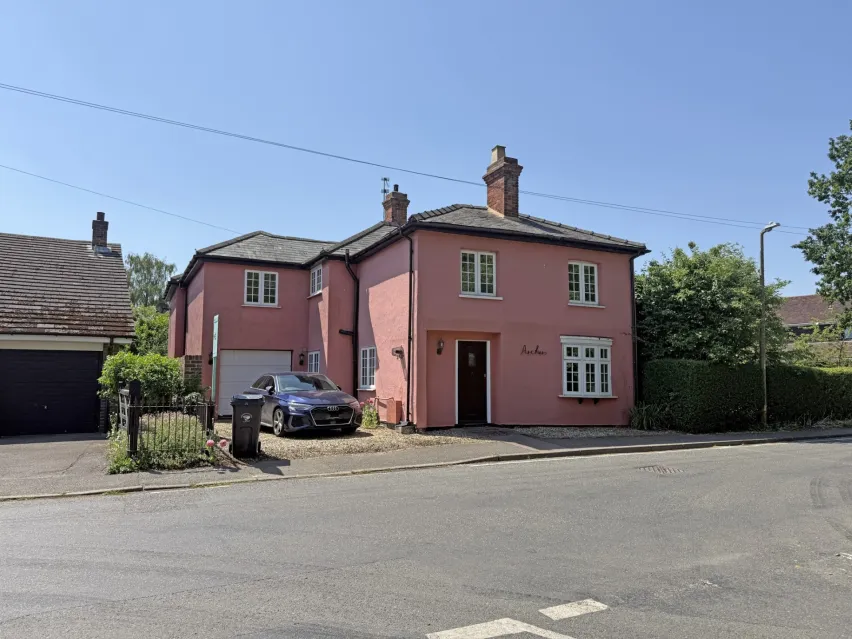 A detached pink cottage in a village location near Chelmsford