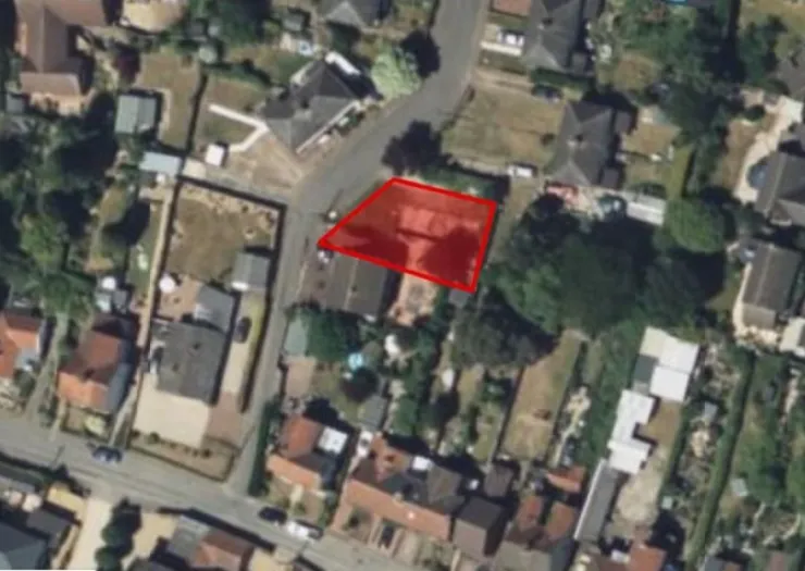 Aerial view of a residential property with a red outline highlighting the plot.