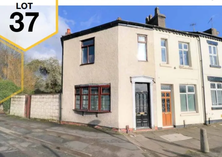 Lot 37: End-terrace house with bay window, black & brown doors, under blue sky.