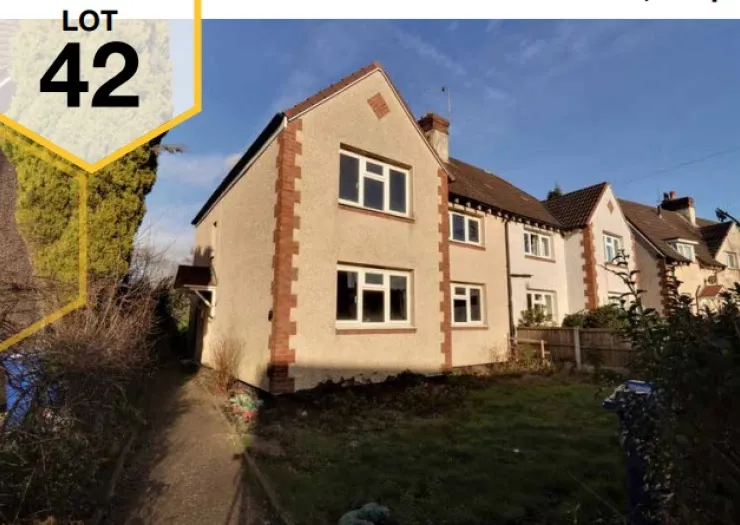 Lot 42, semi-detached house with front garden, pathway, and neighboring properties.