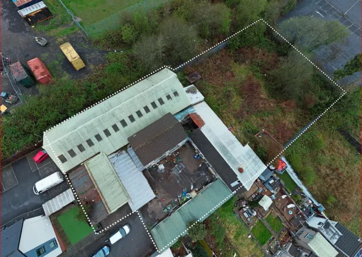 Aerial view of industrial property with outlined development area.