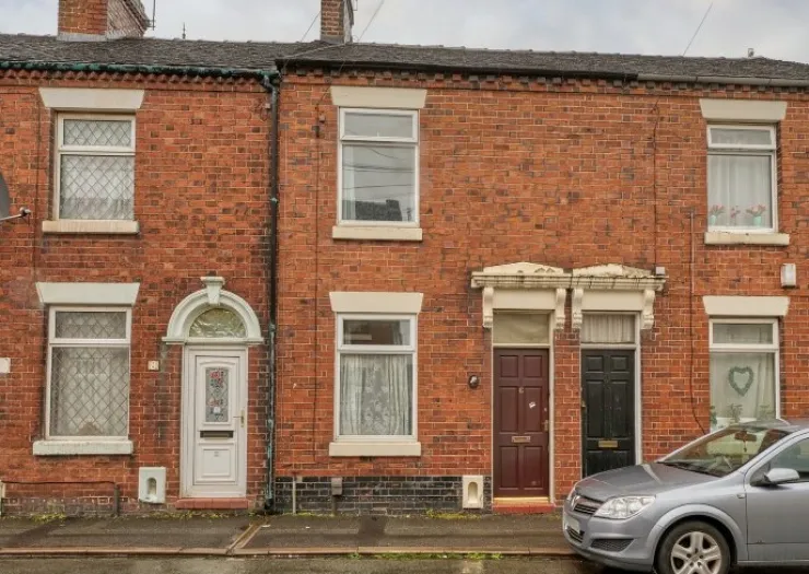 Red brick terraced houses with white and dark wood doors.