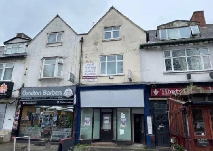 Empty storefront between Chorlton Barbers and Tibat, available for lease.