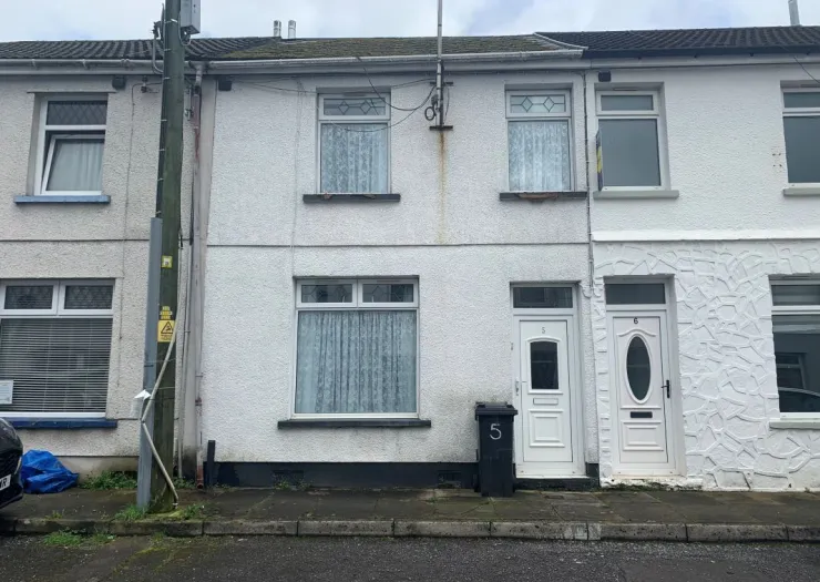 White terraced house exterior with two front doors, numbered 5 and 6.