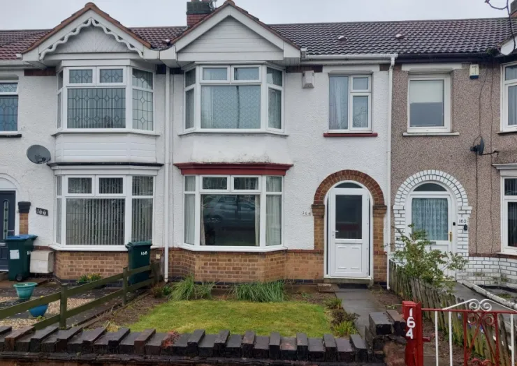 White semi-detached house with bay window, front garden, and red brick accents. Number 164.