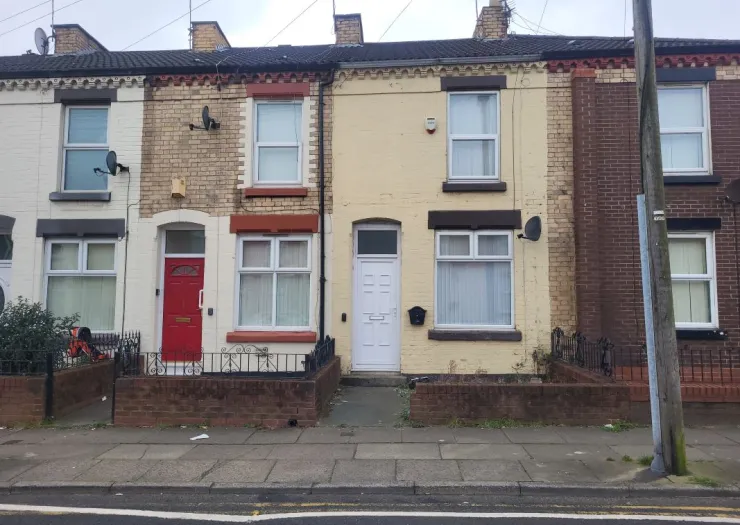 Row of attached terraced houses with brick and painted facades.