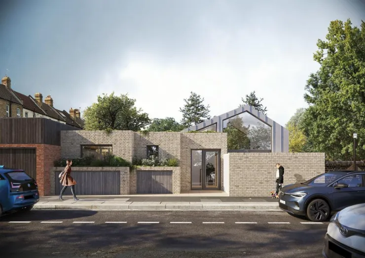 Modern brick house with angled roof and large windows, integrated into a residential street.