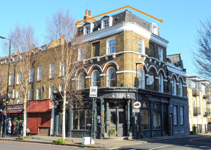London mixed-use building with "Salut!" restaurant on ground floor and apartments above.
