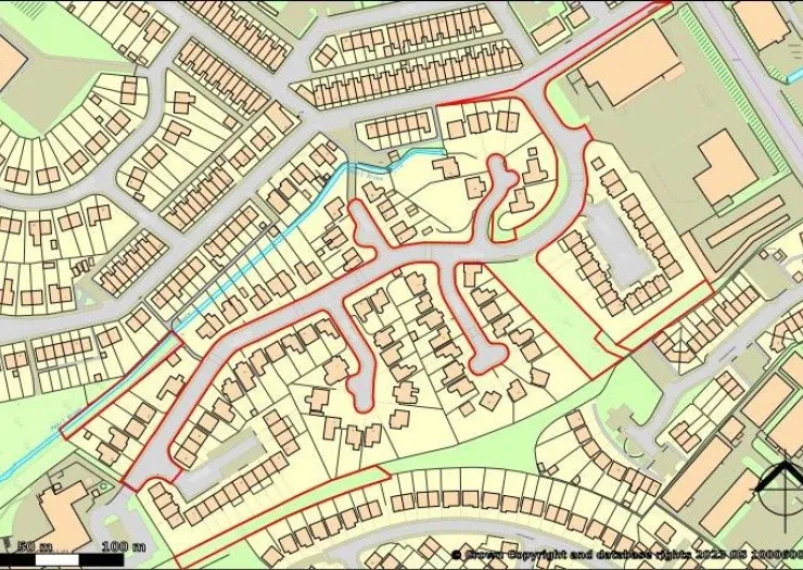 Detailed street map with residential housing, roads, and a small waterway.