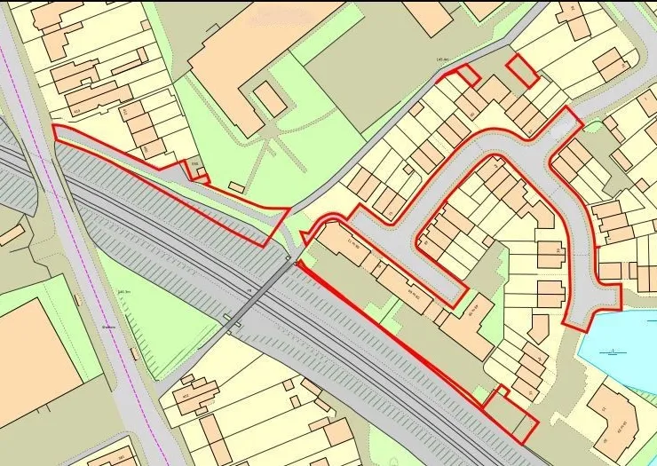 Detailed site map with highlighted property boundaries, adjacent railway, and nearby buildings.