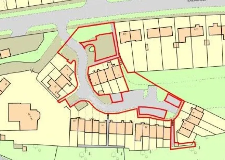 Site plan with outlined housing development, including terraced houses and surrounding roads.