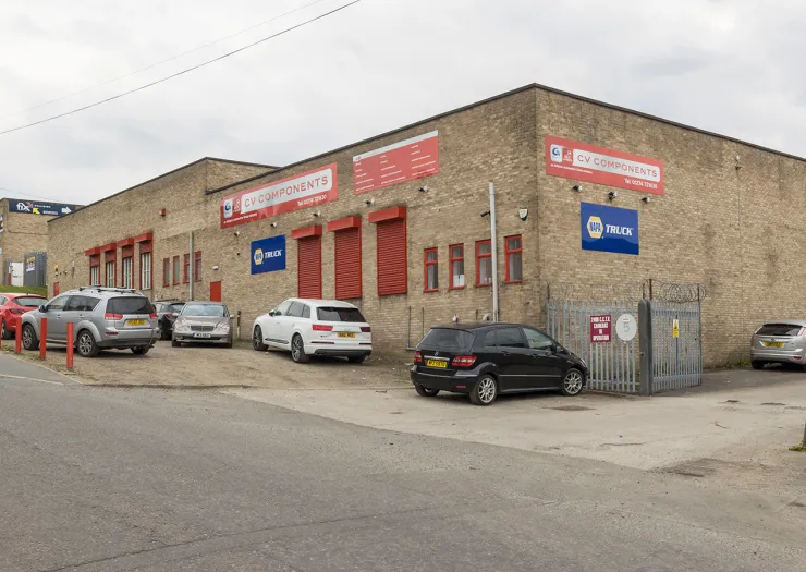 CV Components building exterior with parked cars.
