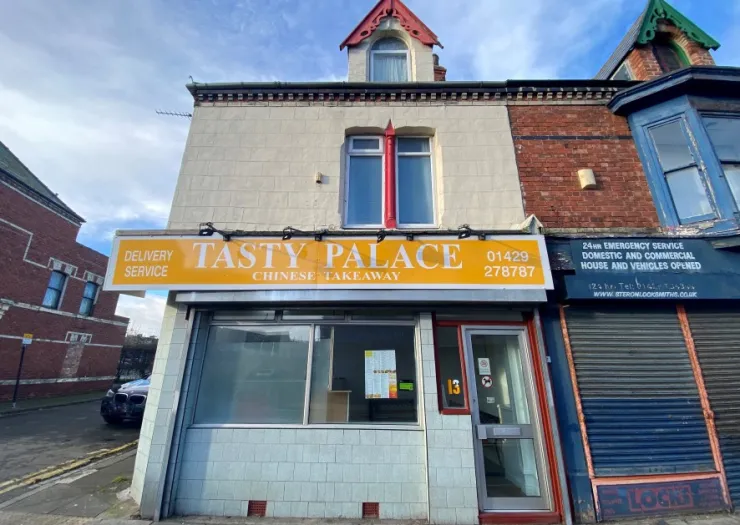 Tasty Palace" Chinese takeaway storefront with delivery service advertised.