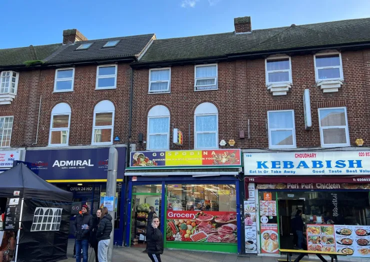 Brick building with street-level shops including "Gospodina" grocery and "Kebabish" restaurant.