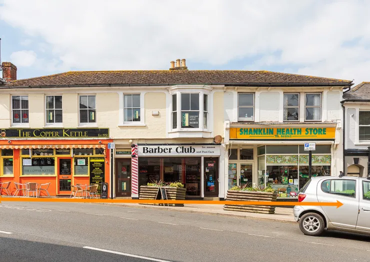Storefronts of "The Copper Kettle," "Barber Club," and "Shanklin Health Store.