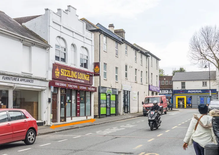 Sizzling Lounge" Indian restaurant storefront on a UK high street.