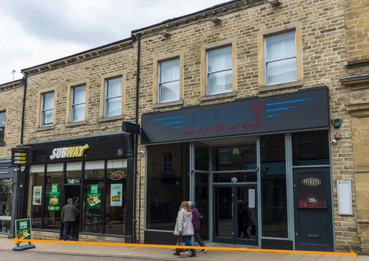 Mixology" bar and Subway restaurant exteriors on a UK high street.