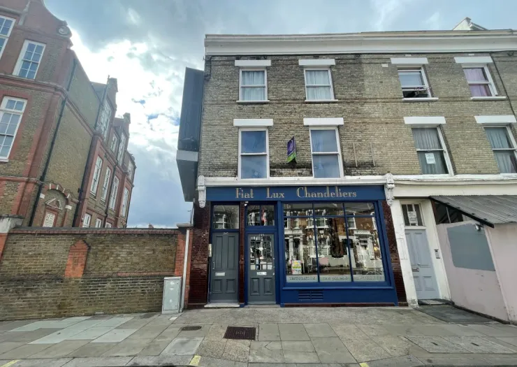 Fiat Lux Chandeliers storefront with blue facade and apartments above.