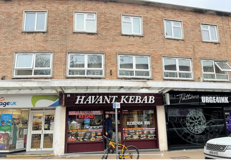 Havant Kebab shop storefront between other businesses, with apartments above.