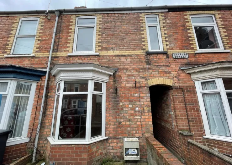 Brick terraced house exterior with bay window on Charles Street.