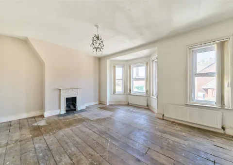 large lounge with fireplace and windows and wood floor