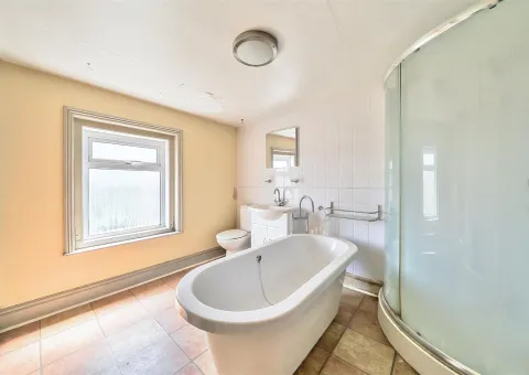 bathroom with freestanding white bath and shower unit