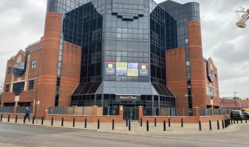 Modern red-brick and glass office building, Bayard Plaza, with "office & studio space" advertised.