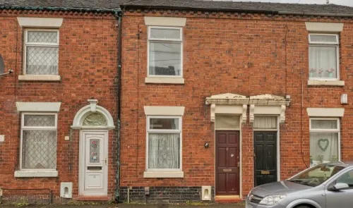 Red brick terraced houses with white and dark wood doors.