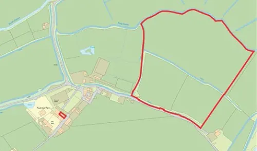 Map outlining a property boundary in red, showing surrounding land, waterways, and nearby buildings.