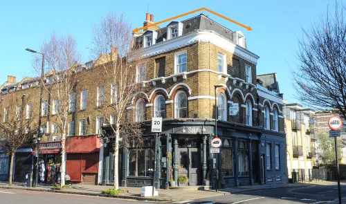 London mixed-use building with "Salut!" restaurant on ground floor and apartments above.