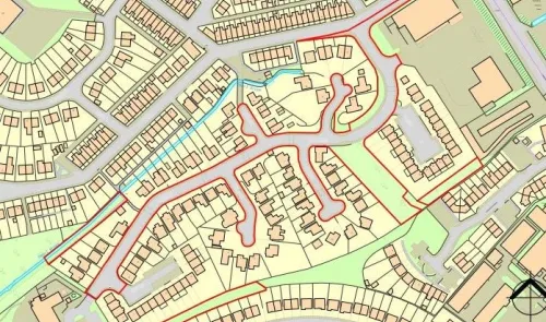 Detailed street map with residential housing, roads, and a small waterway.