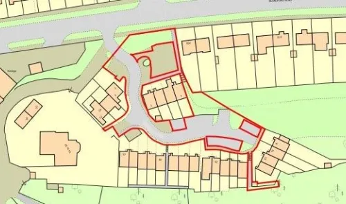 Site plan with outlined housing development, including terraced houses and surrounding roads.