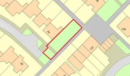 Plot map highlighting a green, rectangular area outlined in red. Surrounding plots and roads are also shown.
