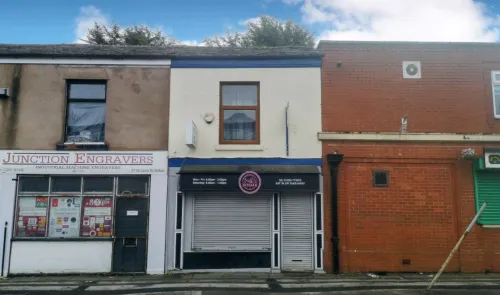 Storefronts of "Jodi's Kitchen" & "Junction Engravers" on a street.