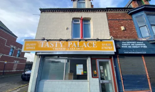 Tasty Palace" Chinese takeaway storefront with delivery service advertised.