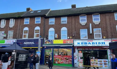 Brick building with street-level shops including "Gospodina" grocery and "Kebabish" restaurant.