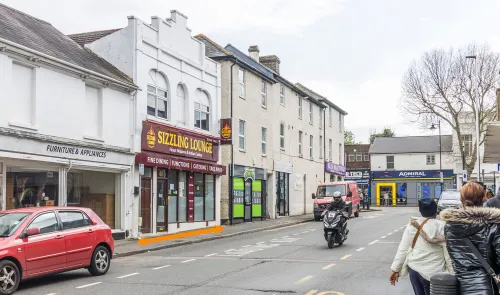 Sizzling Lounge" Indian restaurant storefront on a UK high street.
