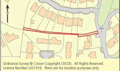 Property boundary highlighted in red on a map of residential area.