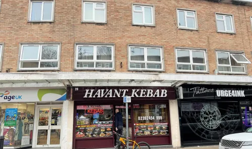 Havant Kebab shop storefront between other businesses, with apartments above.