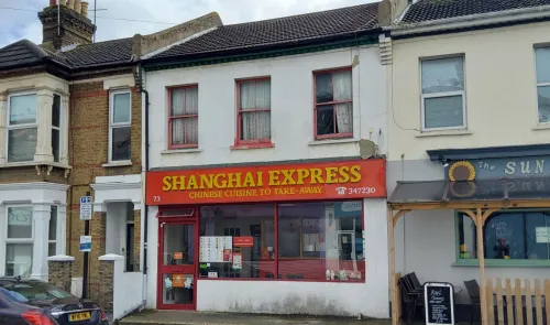 Shanghai Express Chinese takeaway storefront with red signage and visible menu.
