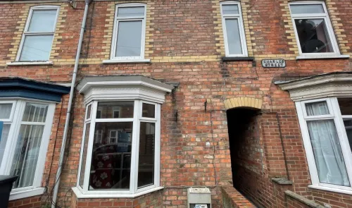 Brick terraced house exterior with bay window on Charles Street.