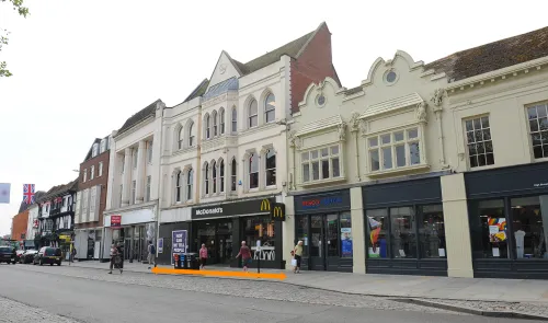 McDonald's and Tesco Express storefronts on a UK high street.