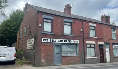 Pat Bell Car Radio storefront in brick building.