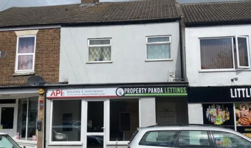 Storefront of "API Building & Investments" and "Property Panda Lettings" with upstairs flats.