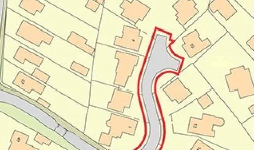 Property site map with a red boundary highlighting a curved road and surrounding houses.