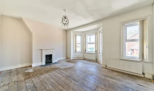 large lounge with fireplace and windows and wood floor