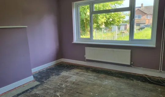 interior of lounge with pink walls and floorboards